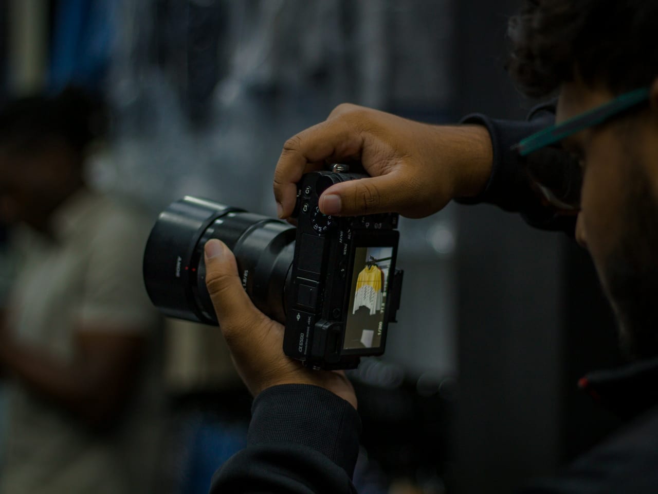 Photographer reviewing a photograph on the back of a camera
