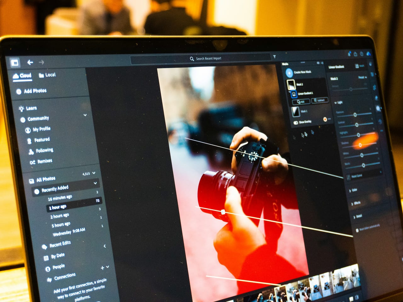 Adobe Lightroom open on a laptop with a photograph and filmstrip visible